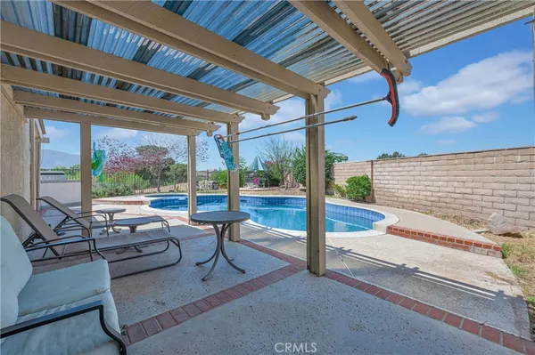 a view of a house with a swimming pool and sitting area