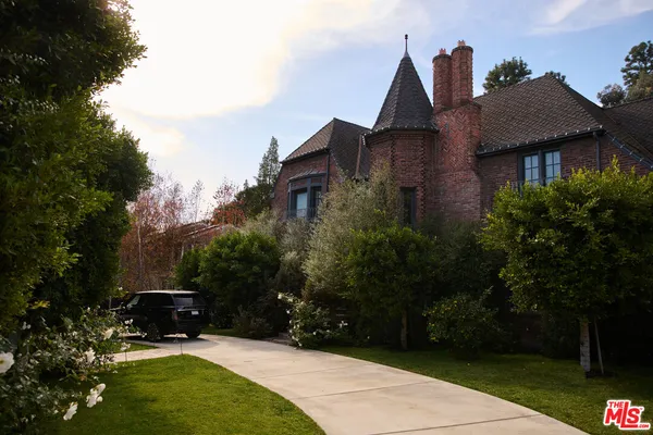 a view of house with yard and green space