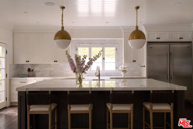a kitchen with granite countertop a sink cabinets and window