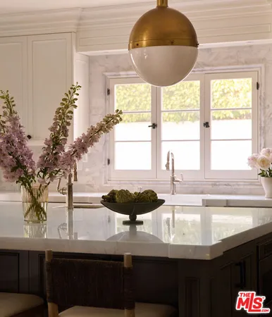 a kitchen with a sink and a large window