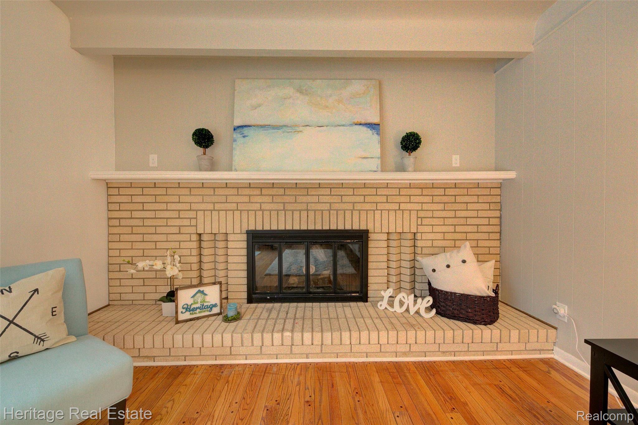 654 Old Perch Road Rochester, MI 48309 - Photo 26 of 61 Cozy up to the fireplace while enjoying views of nature through the sliding glass door in this great family room