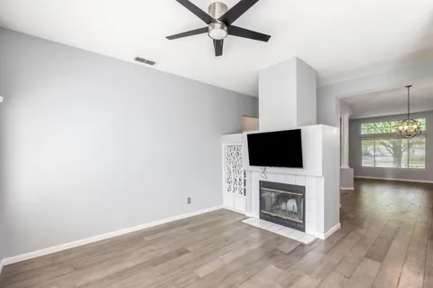 a living room with a fireplace and a flat screen tv