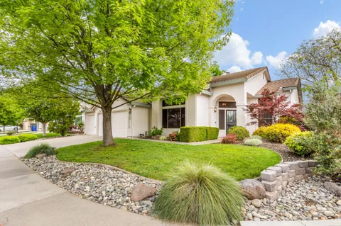 a view of a house with a yard and tree s