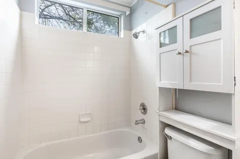 a bathroom with a bathtub and a shower