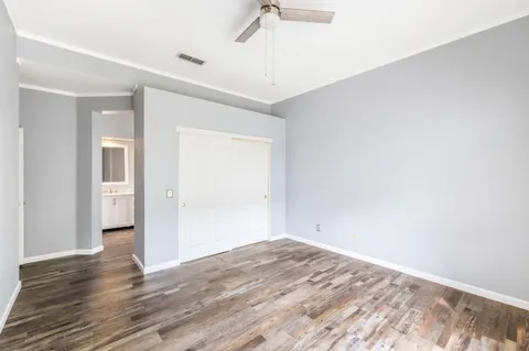 a view of empty room with wooden floor