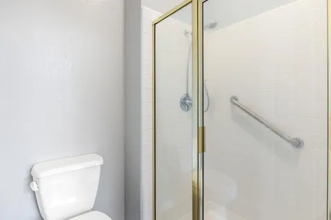 a bathroom with a toilet and a shower