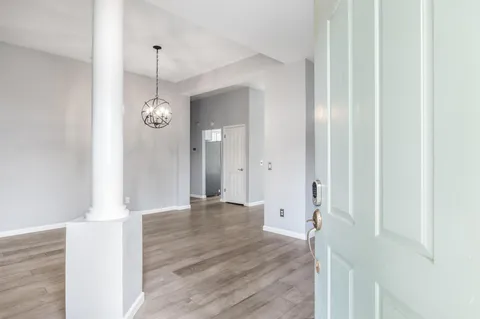 a view of a hallway with wooden floor