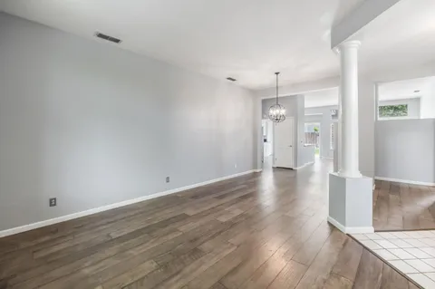 a view of a kitchen with wooden floor and a sink