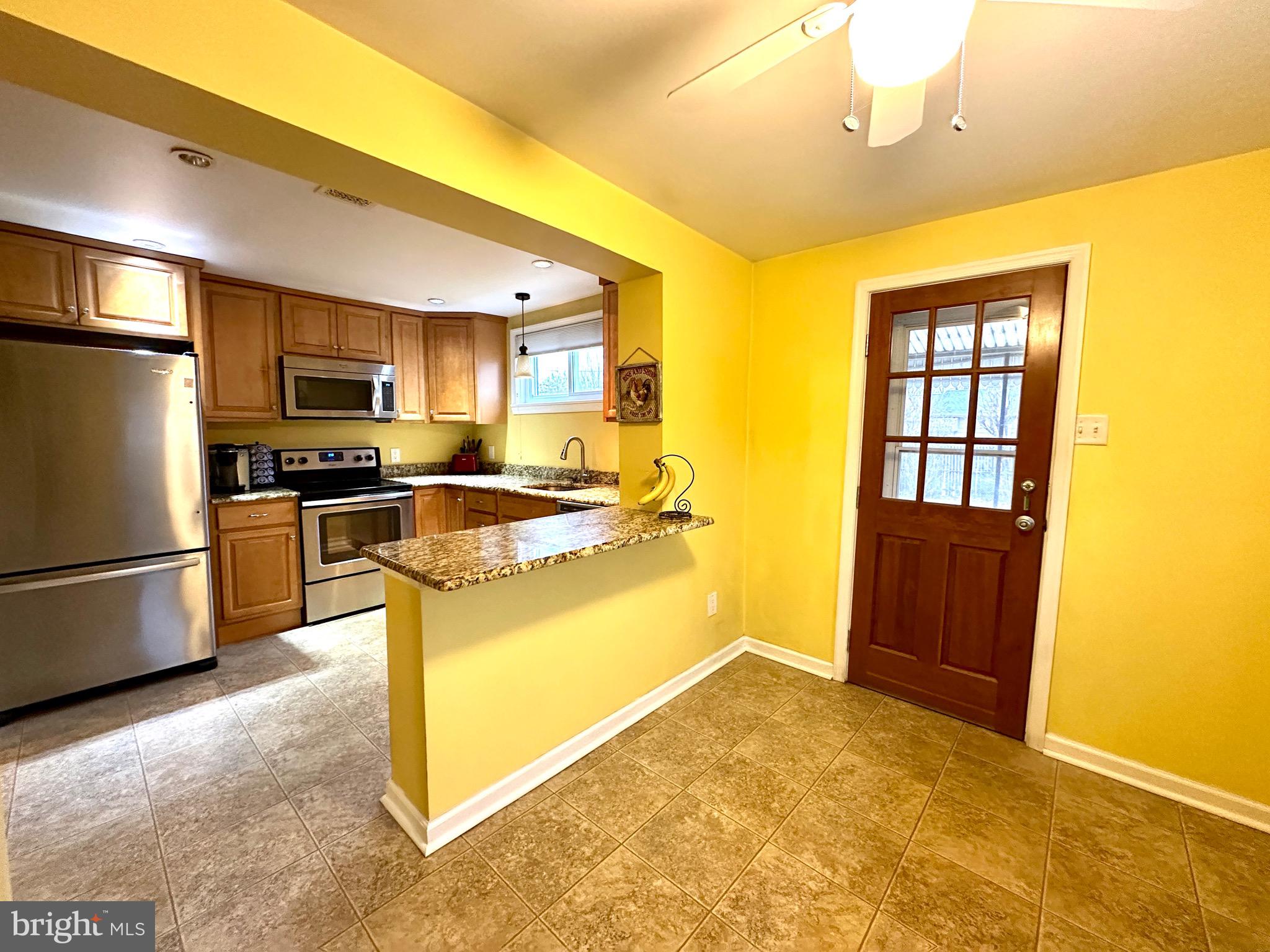 716 Rosa Avenue Croydon, PA 19021 - Photo 12 of 127 a kitchen with stainless steel appliances granite countertop a refrigerator stove top oven and sink