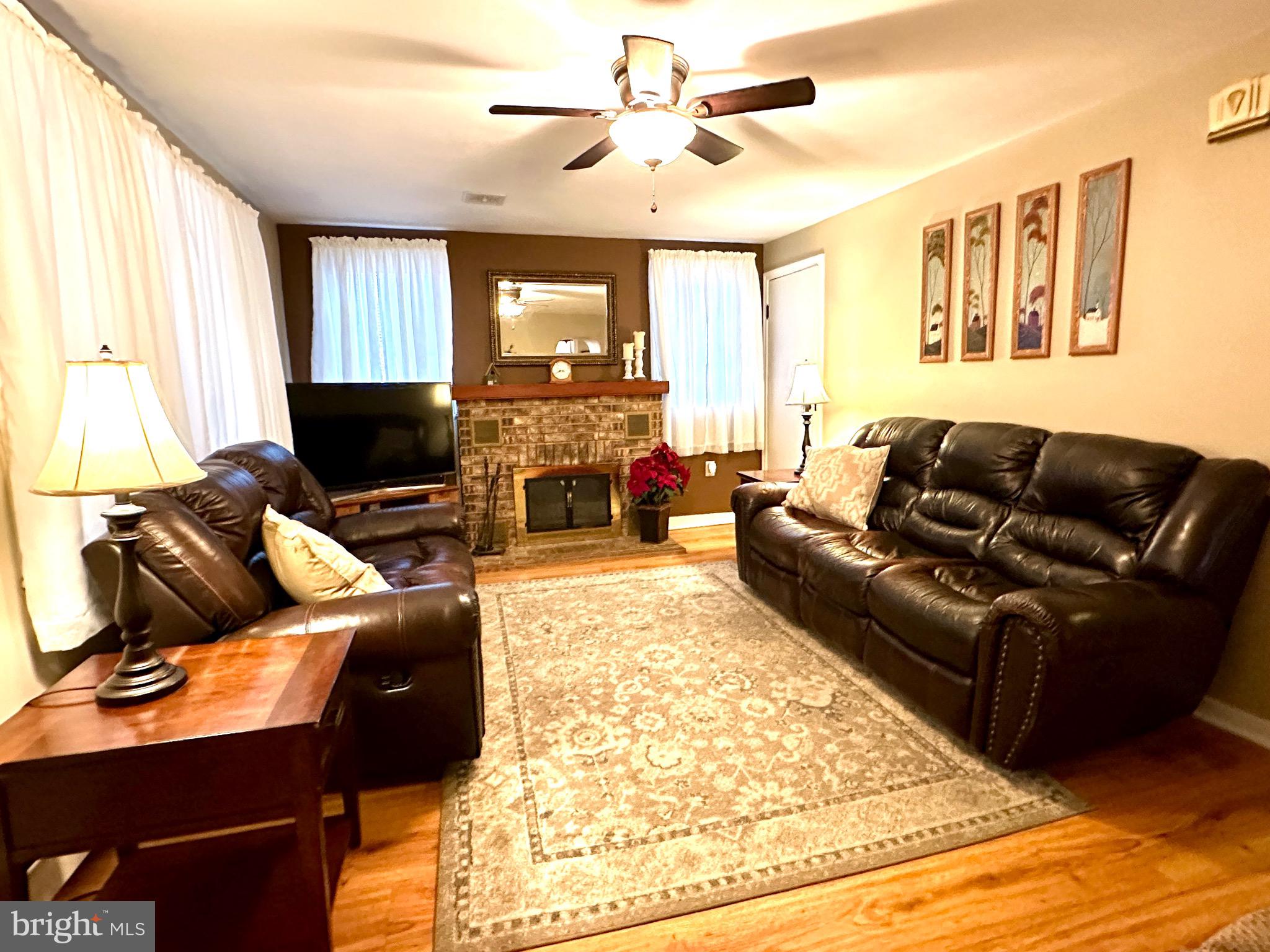 716 Rosa Avenue Croydon, PA 19021 - Photo 6 of 127 a living room with furniture ceiling fan and a fireplace
