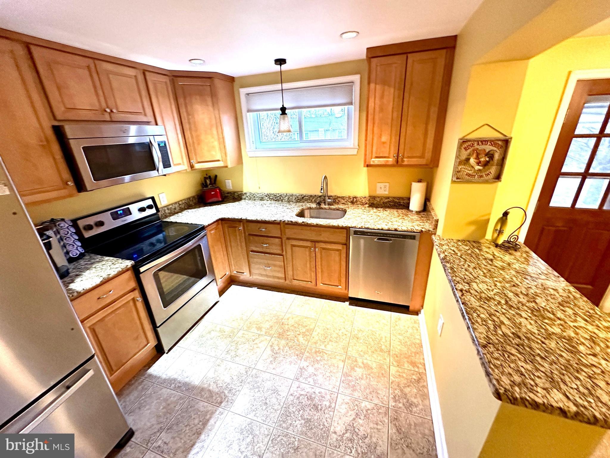 716 Rosa Avenue Croydon, PA 19021 - Photo 83 of 127 a kitchen with stainless steel appliances granite countertop a stove a sink and a microwave