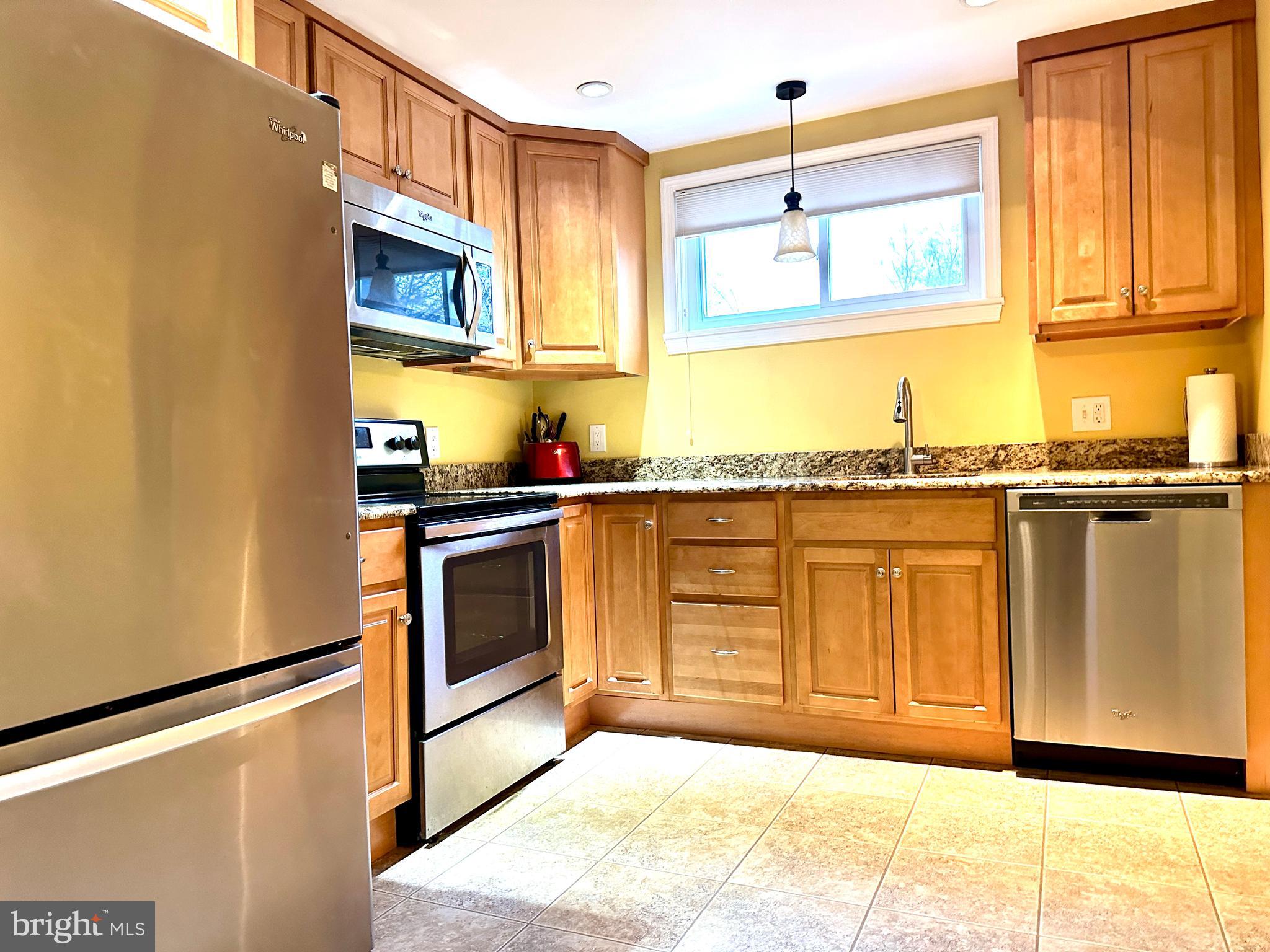 716 Rosa Avenue Croydon, PA 19021 - Photo 88 of 127 a kitchen with stainless steel appliances granite countertop a stove a sink and a microwave