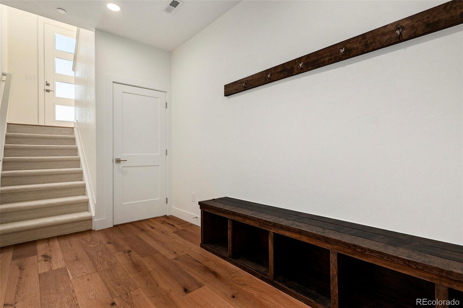 86 High Grove Loop Fraser, CO 80442 - Photo 12 of 20 a room with a bench and wooden floor