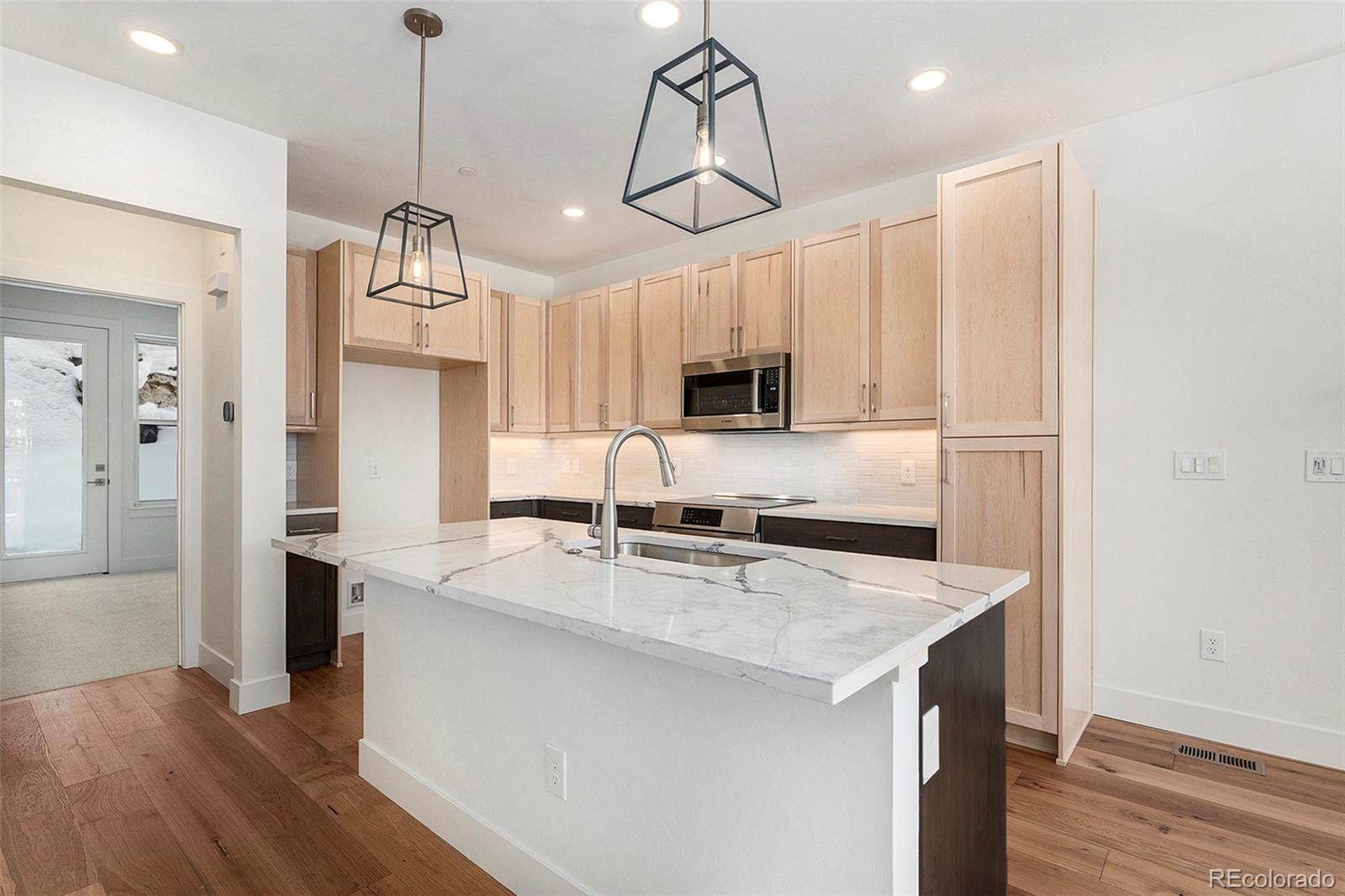 86 High Grove Loop Fraser, CO 80442 - Photo 17 of 20 a kitchen with stainless steel appliances granite countertop a sink a refrigerator and microwave