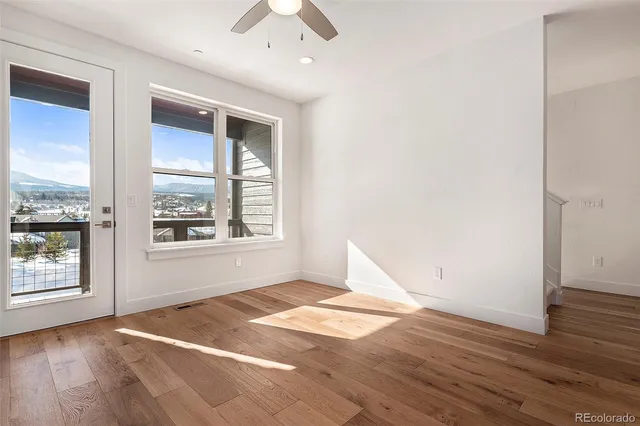 a view of an empty room with a fireplace and a window