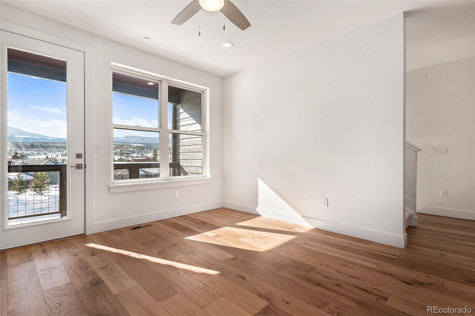 86 High Grove Loop Fraser, CO 80442 - Photo 18 of 20 an empty room with wooden floor and windows