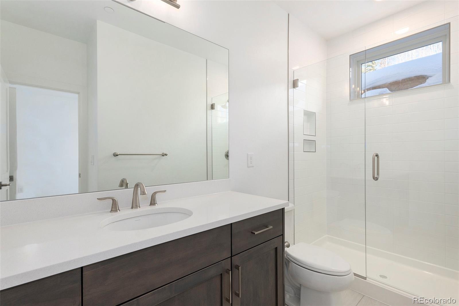 86 High Grove Loop Fraser, CO 80442 - Photo 5 of 20 a bathroom with a sink a toilet and shower