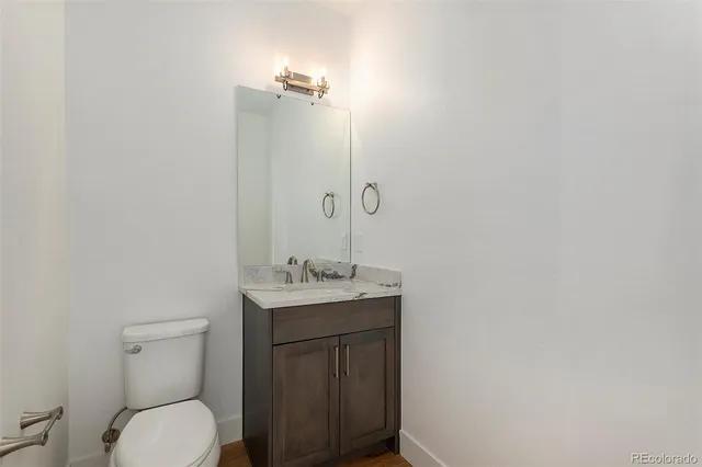 a bathroom with a sink toilet vanity and shower