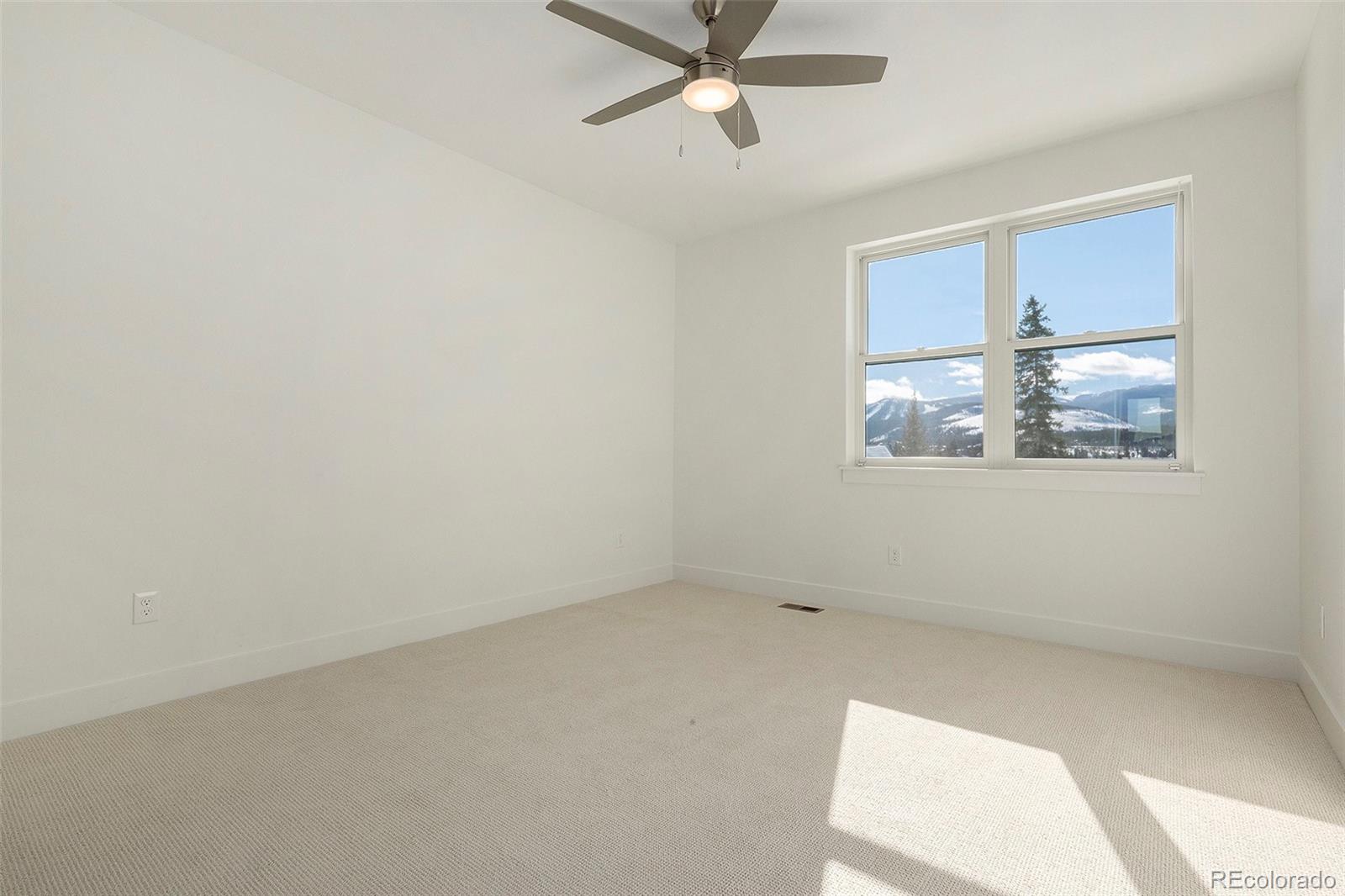 86 High Grove Loop Fraser, CO 80442 - Photo 9 of 20 an empty room with a window and a fan