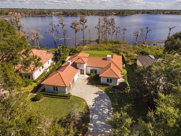 a view of a house with a yard and lake view