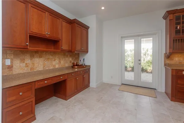 a kitchen with stainless steel appliances granite countertop a sink a stove and a refrigerator