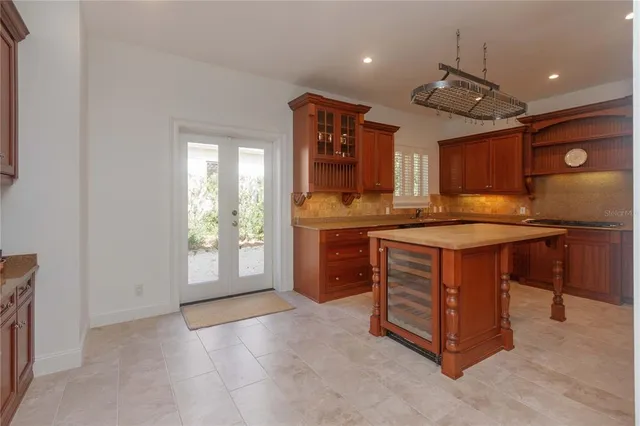a kitchen with kitchen island granite countertop a stove and a sink