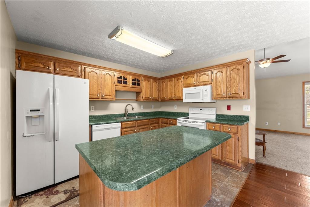 662 Maley Road Jefferson, GA 30549 - Photo 13 of 43 a kitchen with stainless steel appliances granite countertop a sink stove and refrigerator