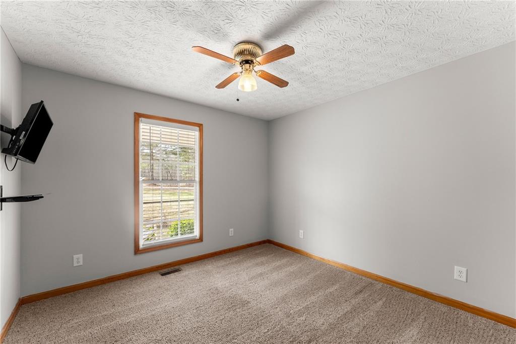 662 Maley Road Jefferson, GA 30549 - Photo 28 of 43 an empty room with windows and fan