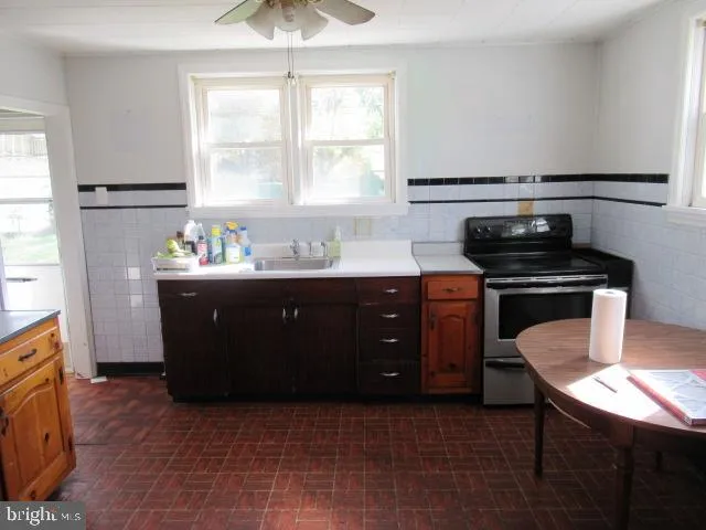 a kitchen with a sink a stove and a window