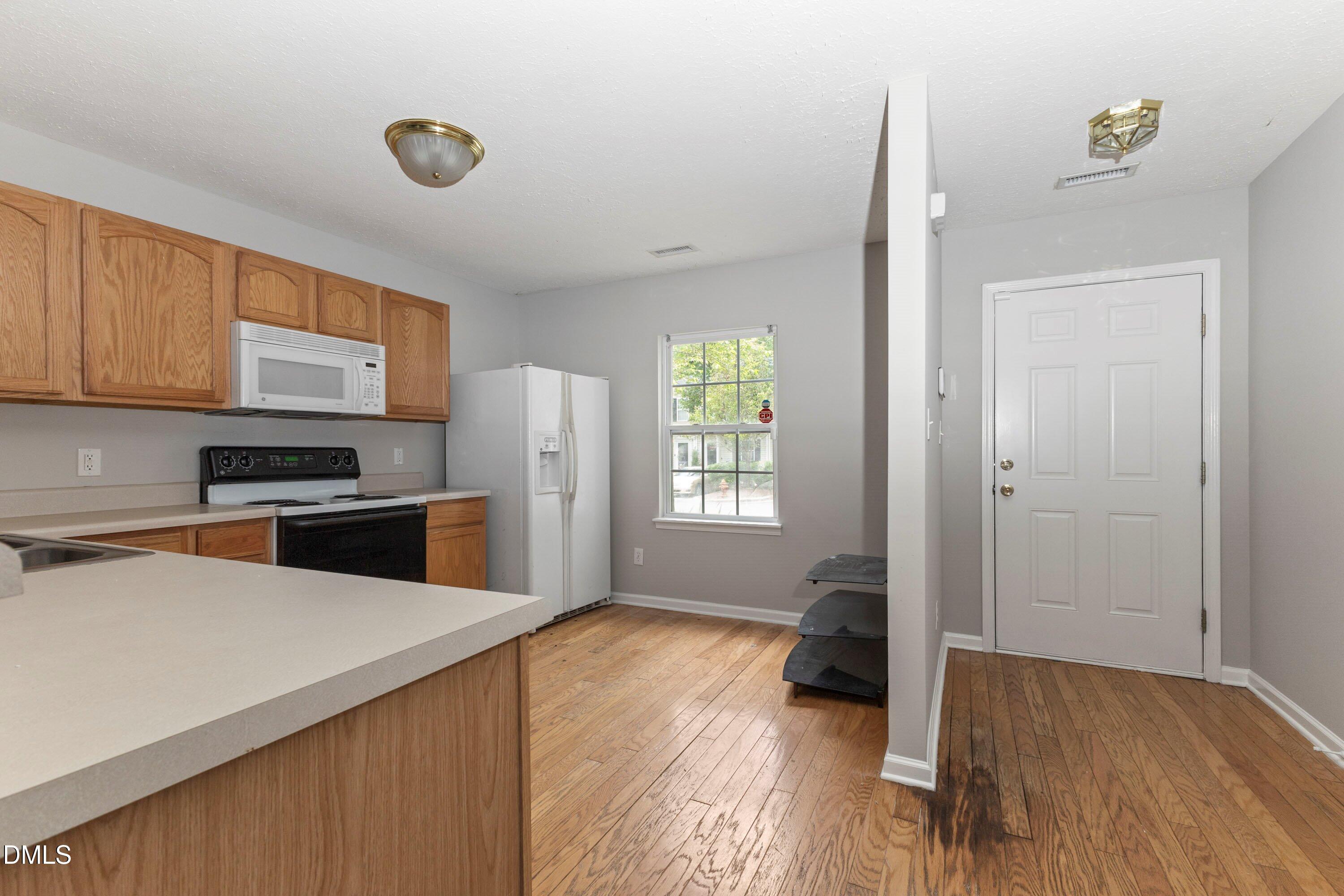 3358 Tarleton West Durham, NC 27713 - Photo 5 of 23 a kitchen with a refrigerator and a stove top oven
