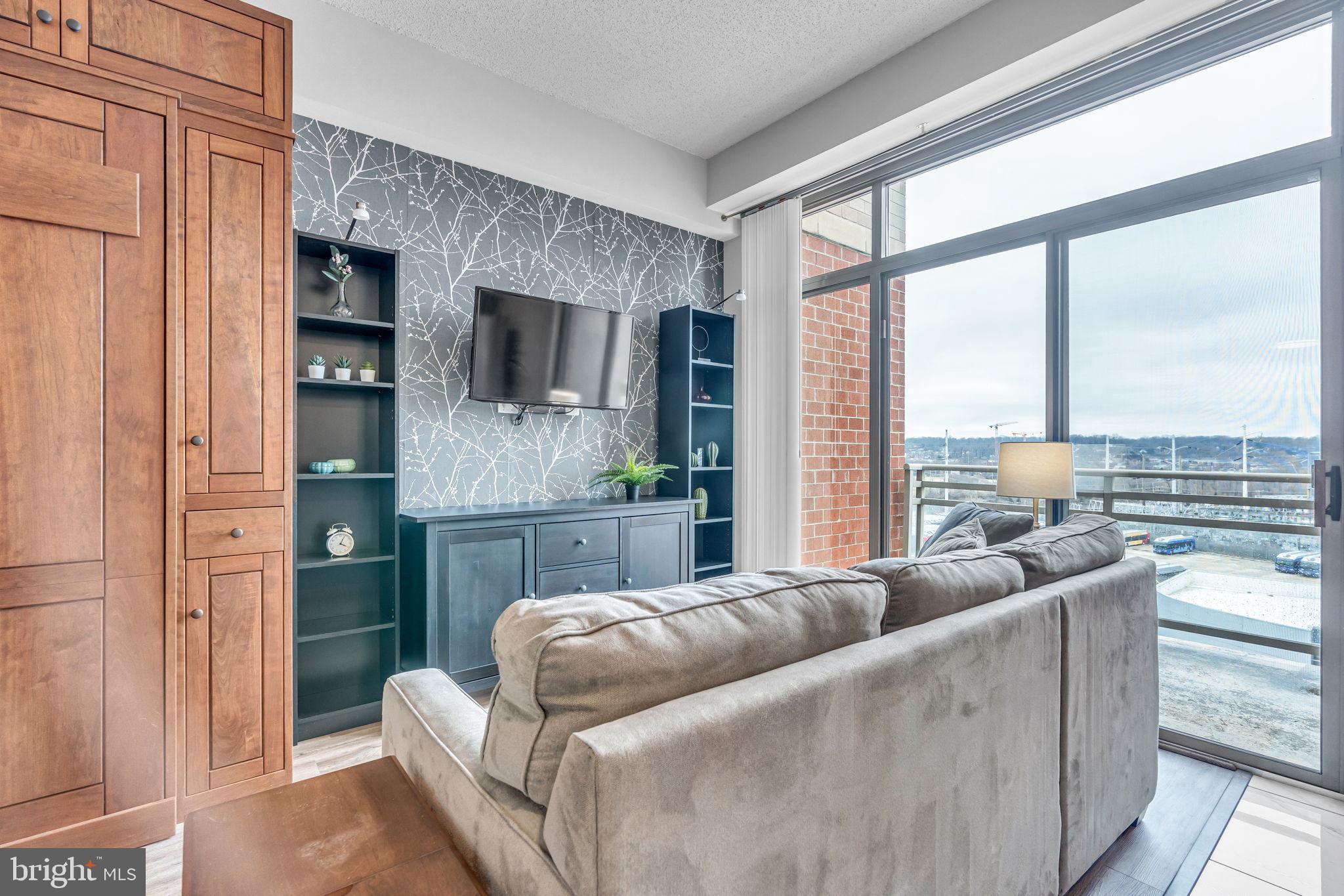 3600 South Glebe Road, Unit 606W Arlington, VA 22202 - Photo 11 of 30 a living room with furniture flat screen tv and a large window