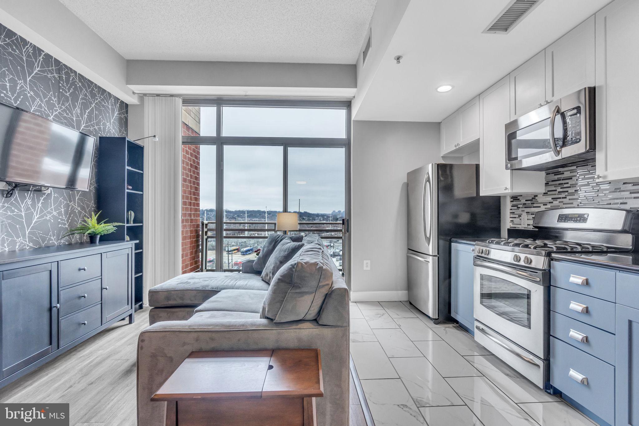 3600 South Glebe Road, Unit 606W Arlington, VA 22202 - Photo 2 of 30 a living room with stainless steel appliances furniture a flat screen tv and a kitchen