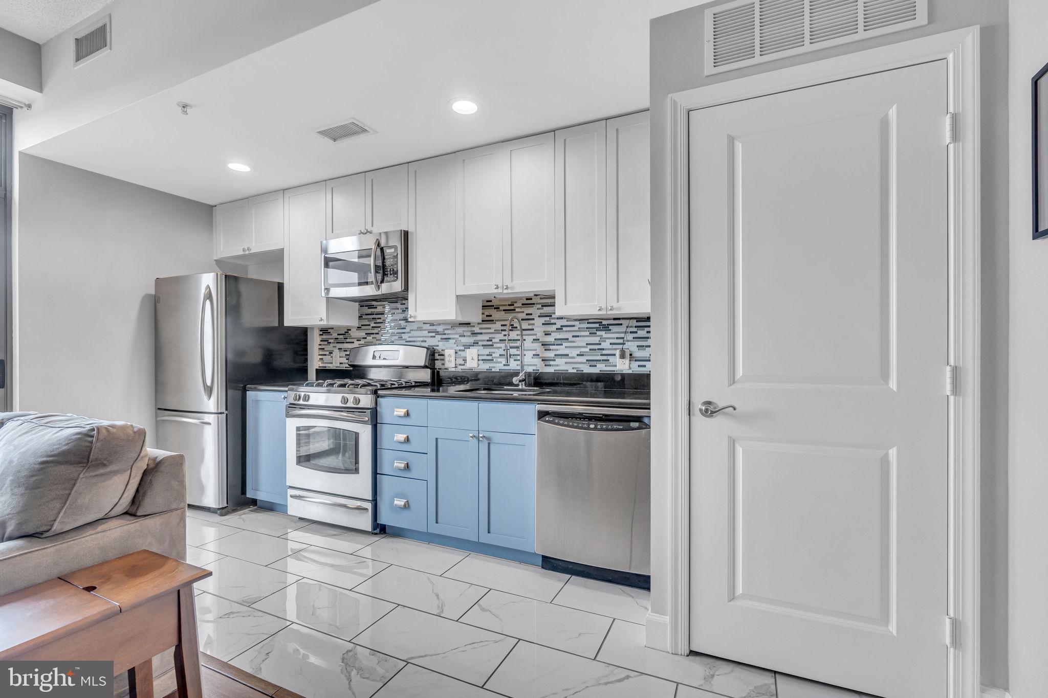 3600 South Glebe Road, Unit 606W Arlington, VA 22202 - Photo 3 of 30 a kitchen with stainless steel appliances granite countertop a refrigerator sink and stove
