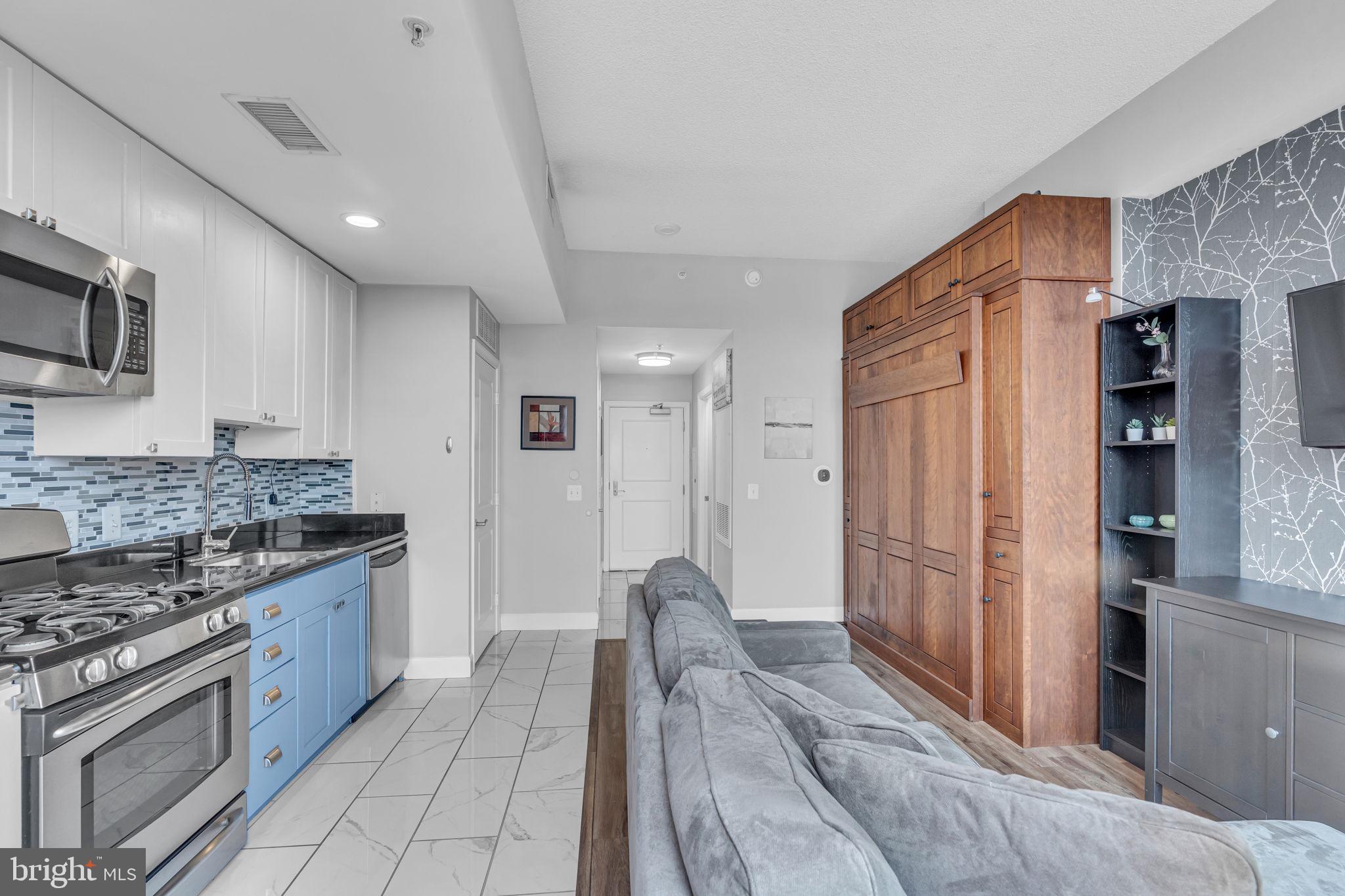 3600 South Glebe Road, Unit 606W Arlington, VA 22202 - Photo 30 of 30 a kitchen with stainless steel appliances granite countertop a refrigerator and a stove top oven