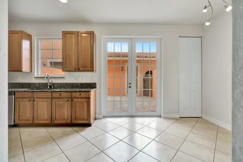 a kitchen with stainless steel appliances granite countertop a refrigerator and a granite counter tops