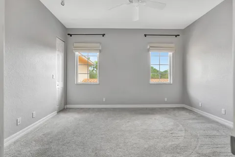 an empty room with a window and a mirror