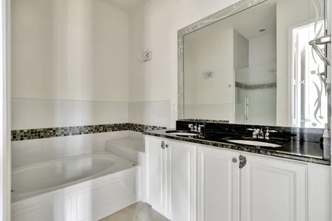 a bathroom with a bathtub and a shower