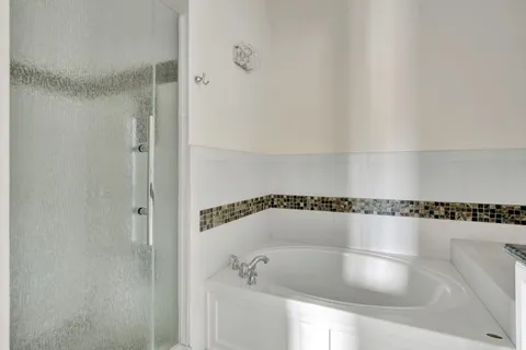a bathroom with a shower and a bathtub