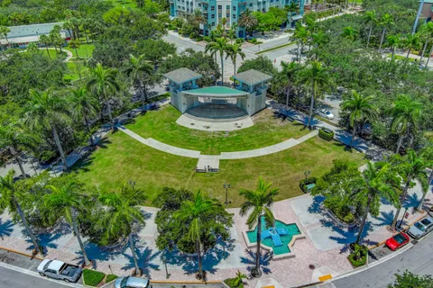 an aerial view of residential houses with outdoor space and trees