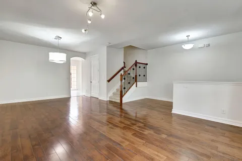 a view of an empty room with wooden floor