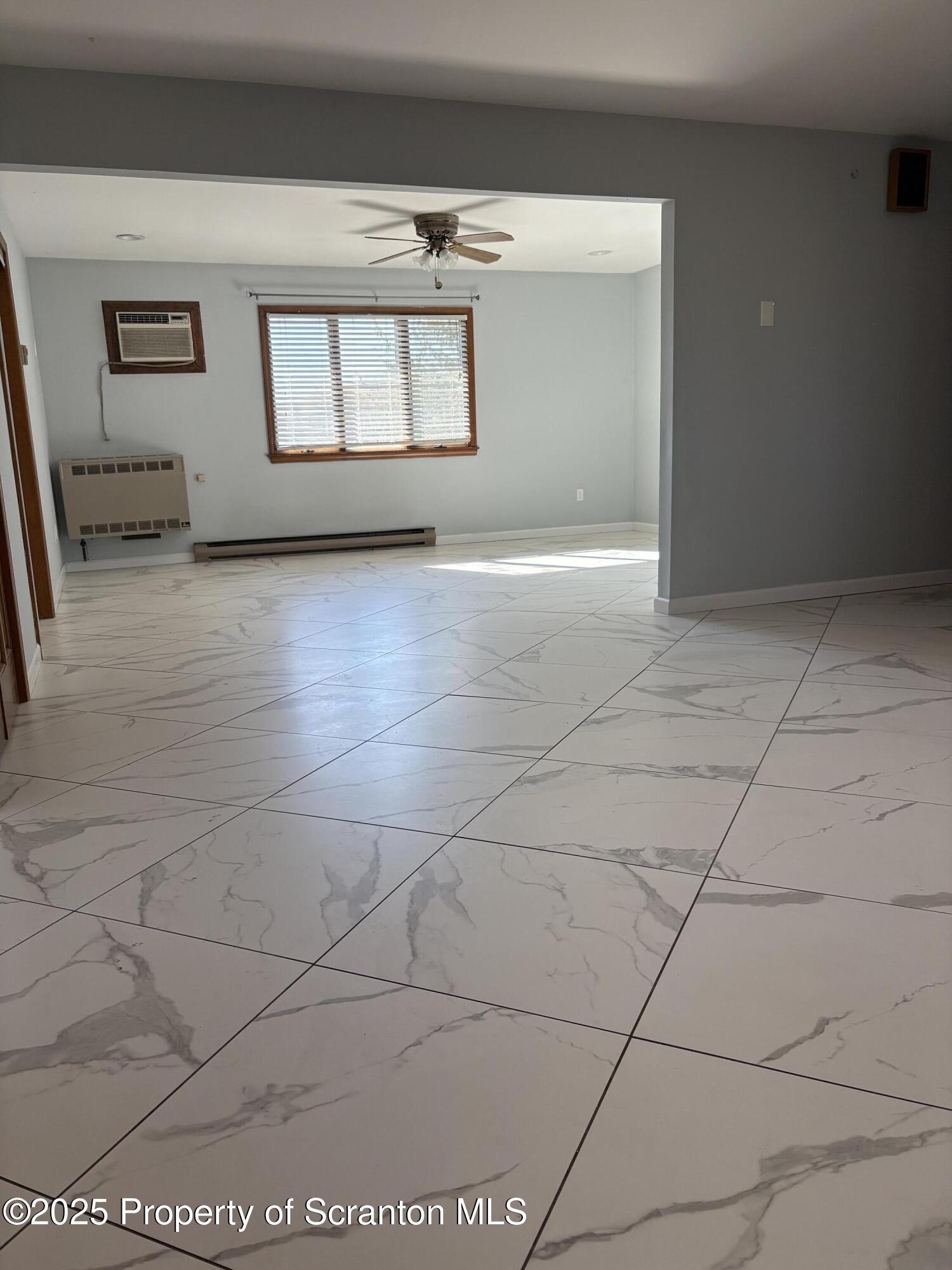 559 Penn Avenue, Unit A Mayfield, PA 18433 - Photo 4 of 9 a view of a livingroom with an empty space and window