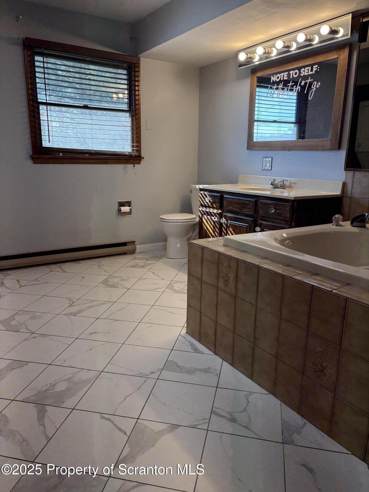 559 Penn Avenue, Unit A Mayfield, PA 18433 - Photo 8 of 9 a room with a washing machine and sink