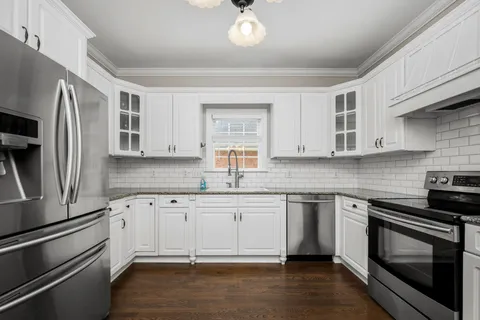 a kitchen with stainless steel appliances granite countertop a stove and a sink