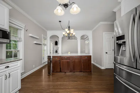 a view of a kitchen center island and stainless steel appliances