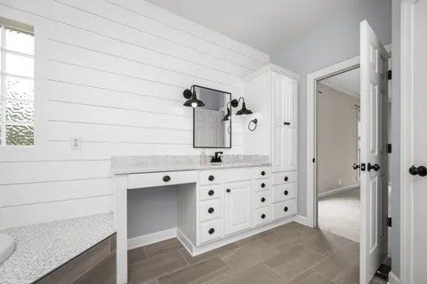 a bathroom with a bathtub sink and mirror