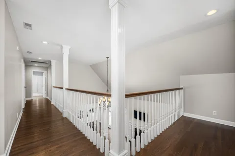 a view of a hallway with wooden floor