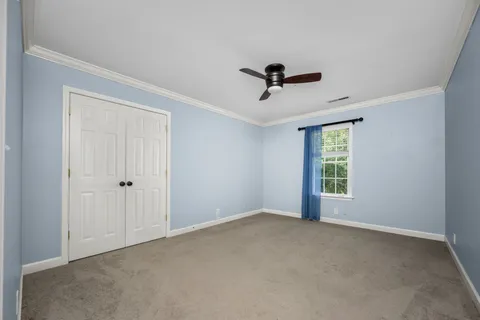 a view of a livingroom with a ceiling fan and window