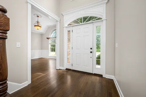 a view of hallway with wooden floor