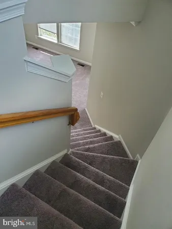a view of staircase with white walls
