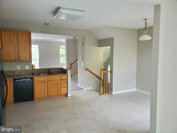 a kitchen with a refrigerator and a stove top oven